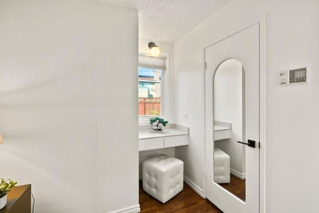 bathroom with hardwood / wood-style floors and a textured ceiling