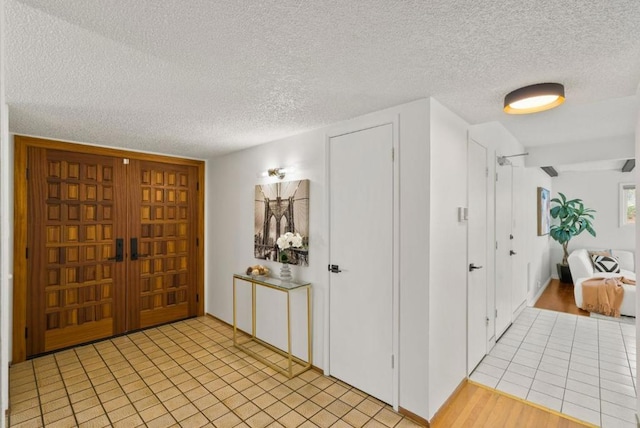 foyer entrance with a textured ceiling