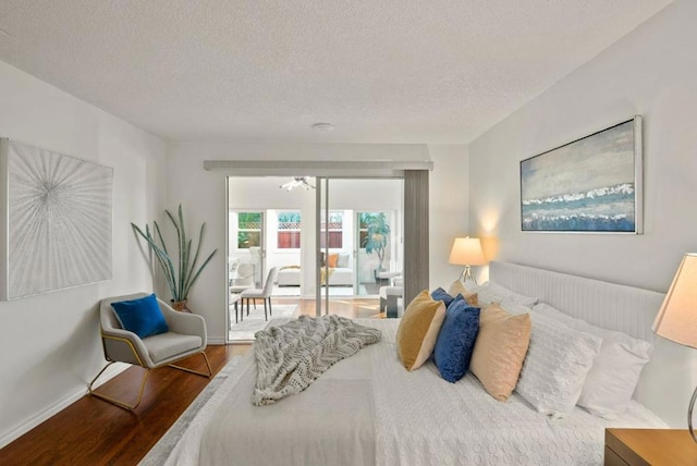 bedroom featuring wood-type flooring and a textured ceiling