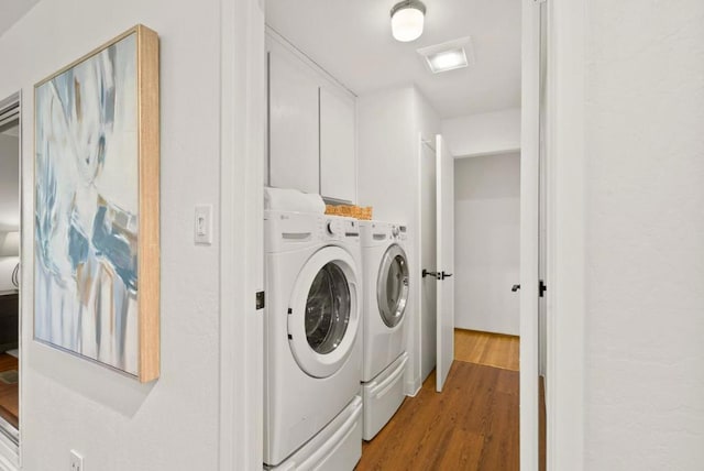 clothes washing area featuring hardwood / wood-style floors and independent washer and dryer