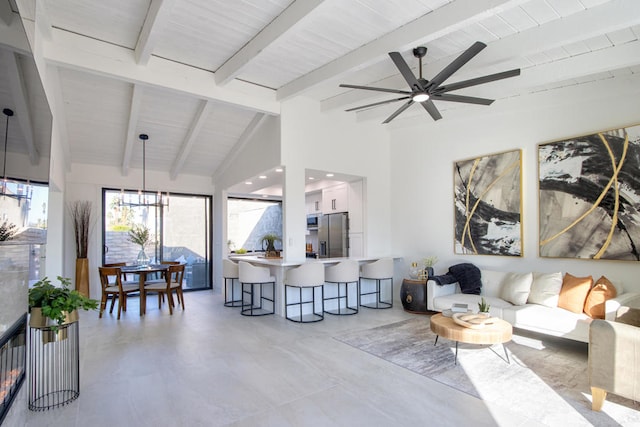 living room featuring vaulted ceiling with beams and ceiling fan