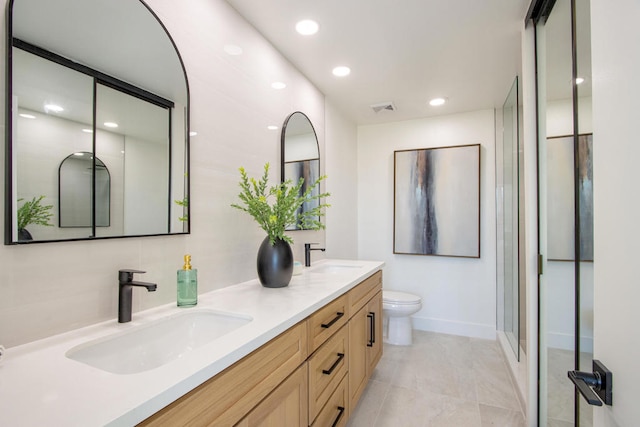 bathroom with vanity, tile patterned flooring, a shower with shower door, and toilet