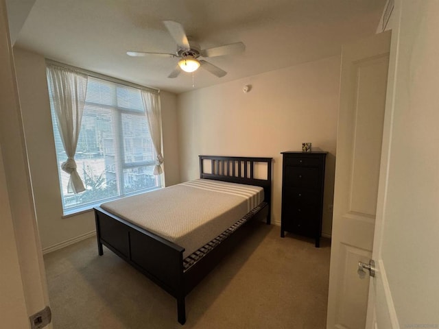 bedroom featuring ceiling fan and carpet