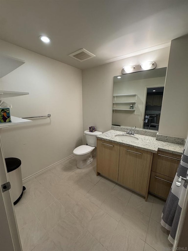 bathroom featuring vanity and toilet