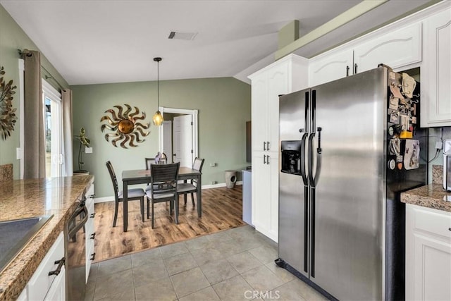 kitchen featuring appliances with stainless steel finishes, pendant lighting, and white cabinets