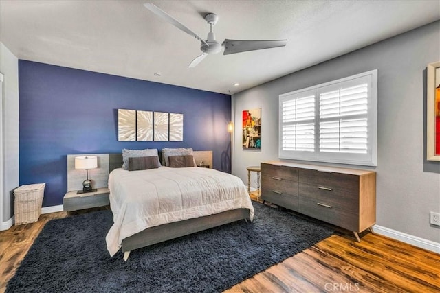 bedroom featuring ceiling fan and dark hardwood / wood-style flooring