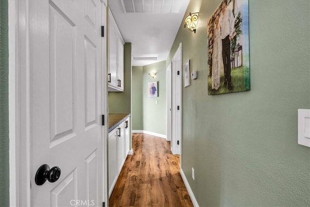 hallway with hardwood / wood-style flooring