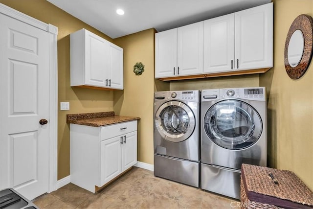 laundry area featuring cabinets and washing machine and clothes dryer