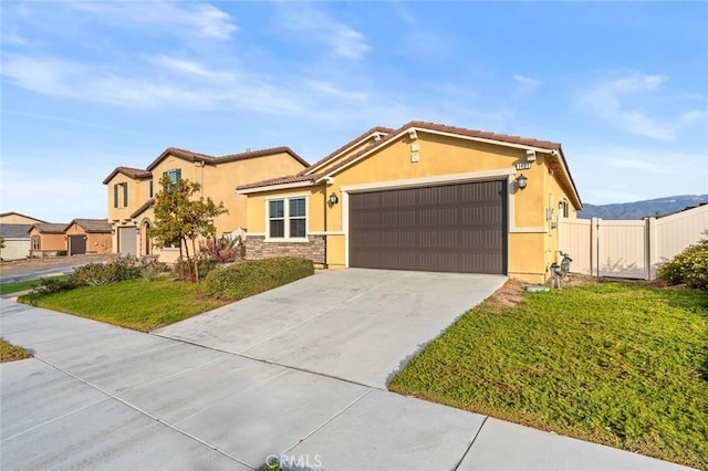 view of front of property featuring a garage and a front lawn