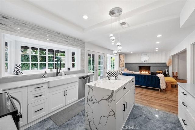 kitchen featuring a kitchen island, white cabinetry, dishwasher, sink, and black electric range oven