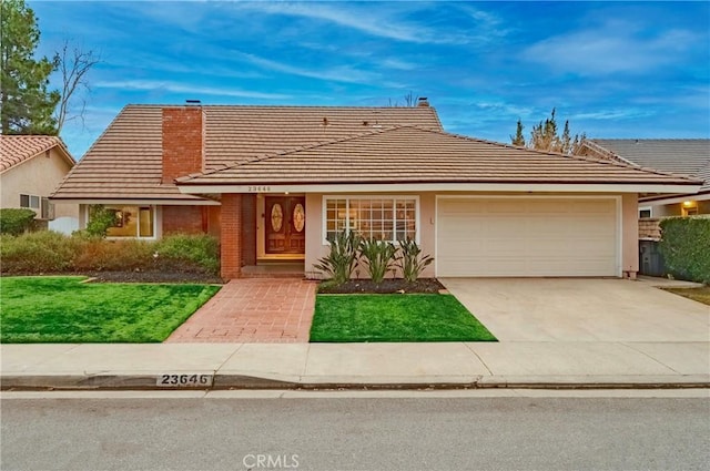 view of front facade with a garage and a front lawn