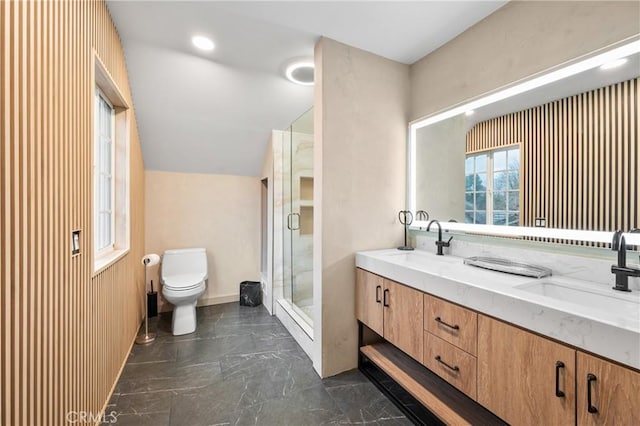 bathroom with vaulted ceiling, vanity, toilet, and a shower with door