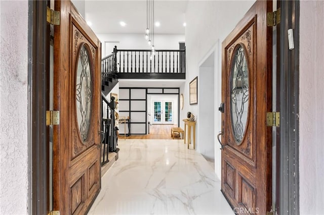 entryway with french doors and a high ceiling