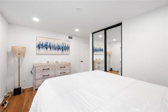 bedroom featuring a closet and light wood-type flooring