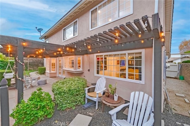 rear view of house with a pergola and a patio