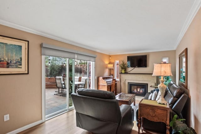 living room with ornamental molding and light hardwood / wood-style floors