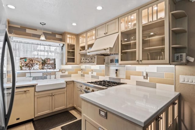 kitchen with pendant lighting, sink, decorative backsplash, and light tile patterned flooring