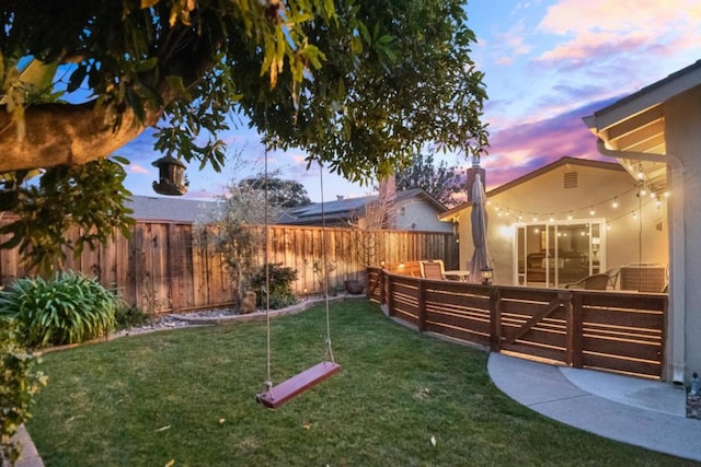 yard at dusk featuring an outdoor living space