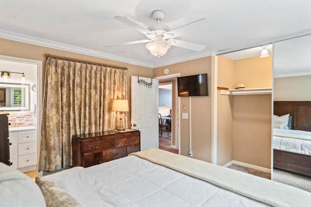 bedroom featuring crown molding, ceiling fan, ensuite bathroom, and a closet