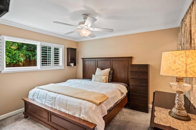 carpeted bedroom with crown molding and ceiling fan