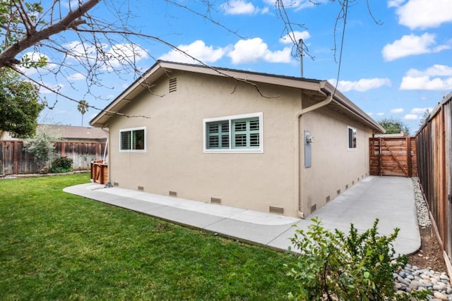 rear view of property with a lawn and a patio area