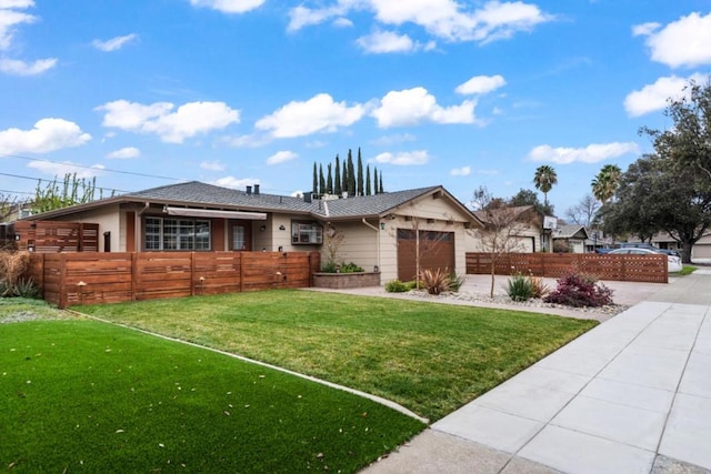 view of front of home with a garage and a front lawn