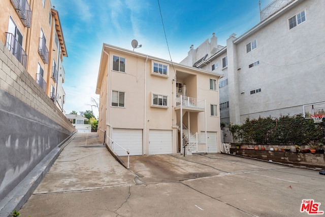 rear view of property with a garage