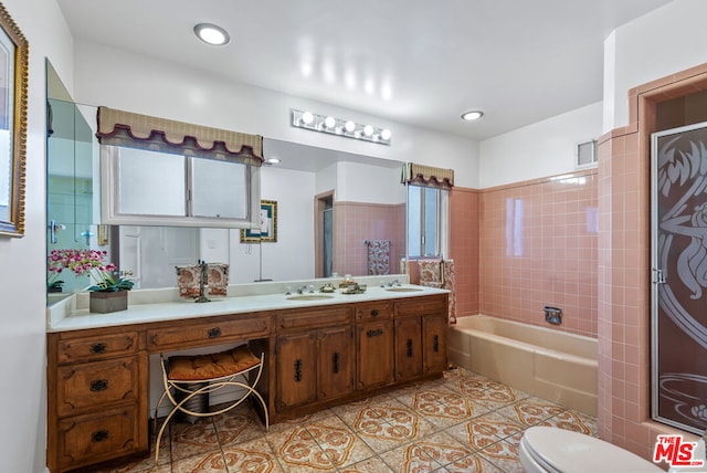 full bathroom featuring tiled shower / bath, tile patterned floors, toilet, and vanity