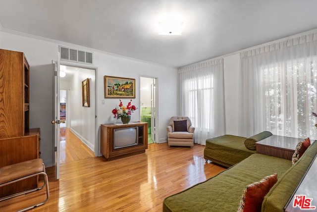 living room with hardwood / wood-style floors and ornamental molding