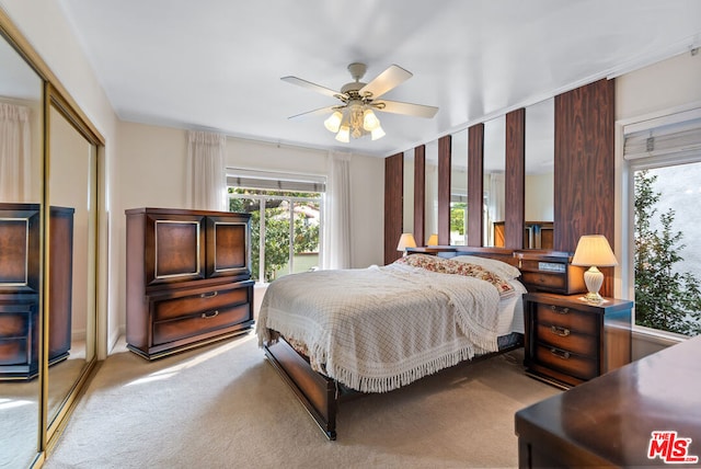 bedroom with light colored carpet, a closet, and ceiling fan