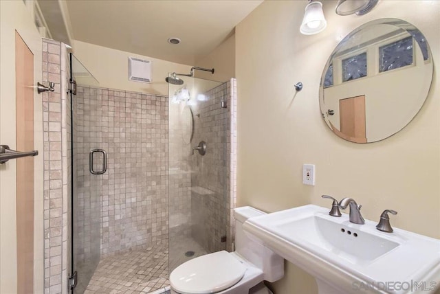 bathroom featuring sink, toilet, and walk in shower