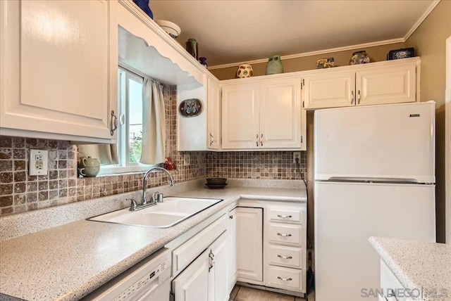 kitchen featuring white cabinetry, sink, backsplash, and white appliances