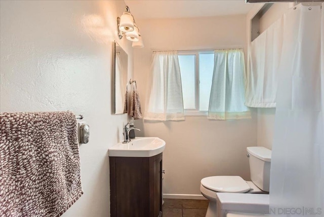 bathroom with vanity, toilet, and tile patterned flooring