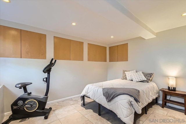 bedroom featuring beamed ceiling and light tile patterned floors