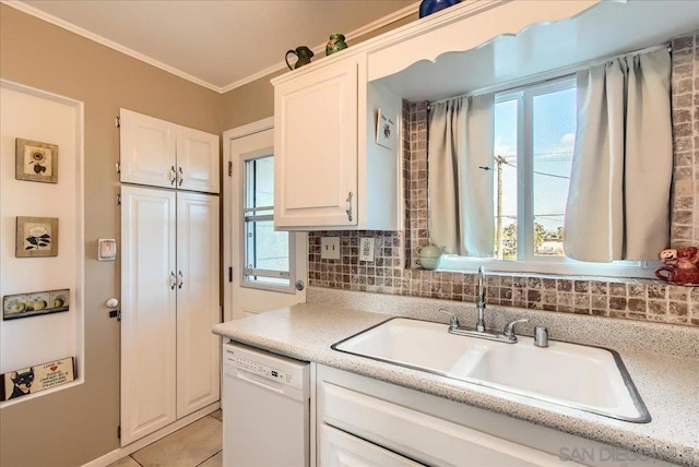 kitchen with sink, ornamental molding, white dishwasher, decorative backsplash, and white cabinets