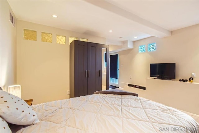 bedroom with beam ceiling