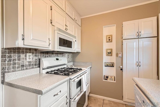 kitchen featuring light tile patterned floors, white cabinets, white appliances, and decorative backsplash