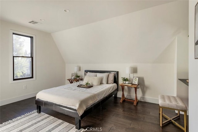 bedroom with lofted ceiling and dark hardwood / wood-style flooring