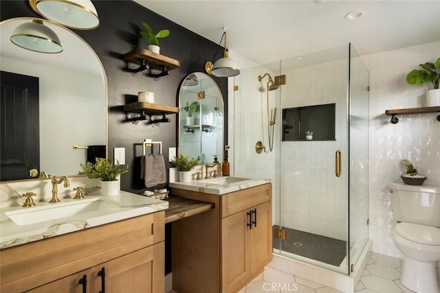 bathroom with vanity, tile patterned floors, toilet, and walk in shower