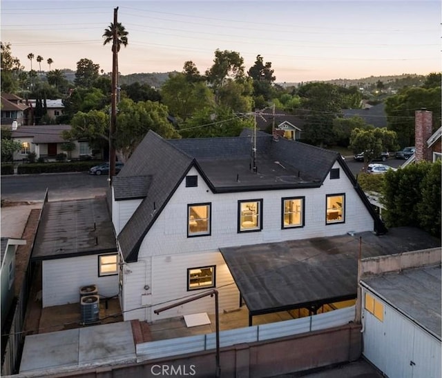 back house at dusk with cooling unit