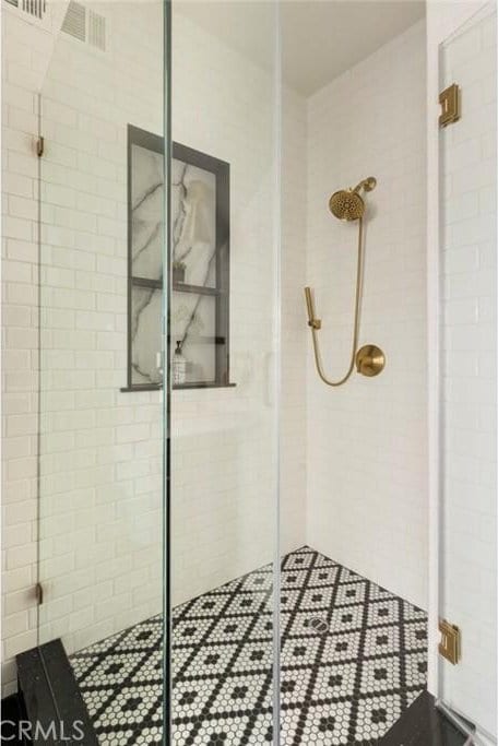 bathroom with a shower with shower door