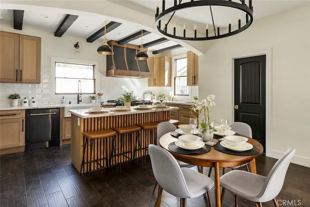 dining room featuring beamed ceiling, dark hardwood / wood-style floors, and sink