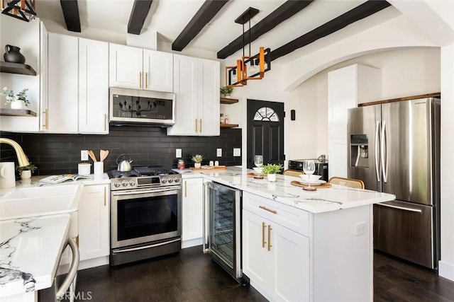 kitchen featuring sink, stainless steel appliances, wine cooler, light stone countertops, and white cabinets