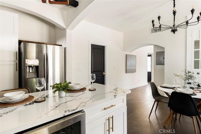 kitchen featuring stainless steel fridge, wine cooler, light stone counters, white cabinets, and dark hardwood / wood-style flooring