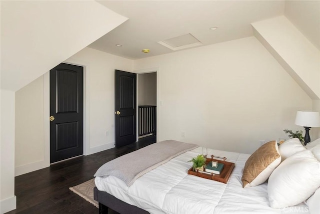 bedroom featuring lofted ceiling and dark hardwood / wood-style floors