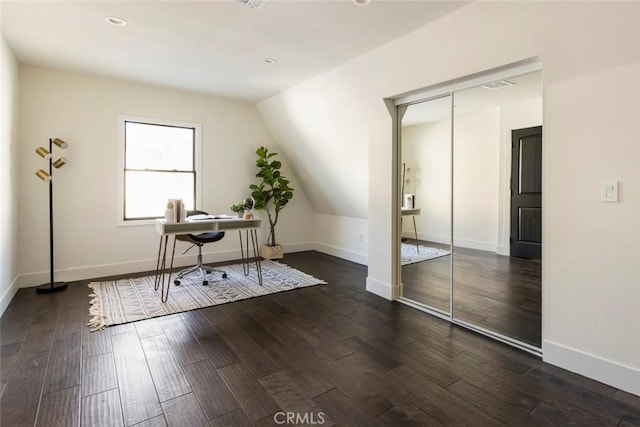 home office featuring dark hardwood / wood-style floors and vaulted ceiling