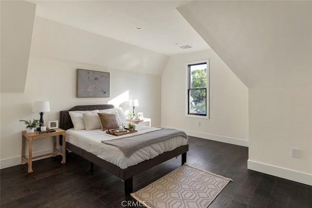 bedroom featuring vaulted ceiling and dark wood-type flooring