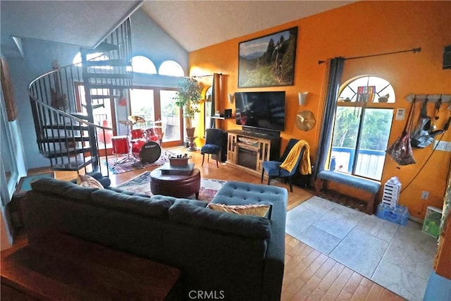 living room featuring hardwood / wood-style floors and high vaulted ceiling