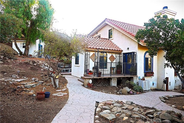 exterior space with a wooden deck and central AC unit