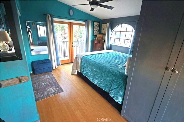 bedroom featuring lofted ceiling, light hardwood / wood-style flooring, ceiling fan, access to exterior, and french doors